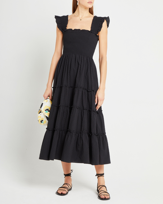 First image of Calypso Maxi Dress, a black maxi dress, swiss dot material, smocked bodice, ruffles cap sleeves