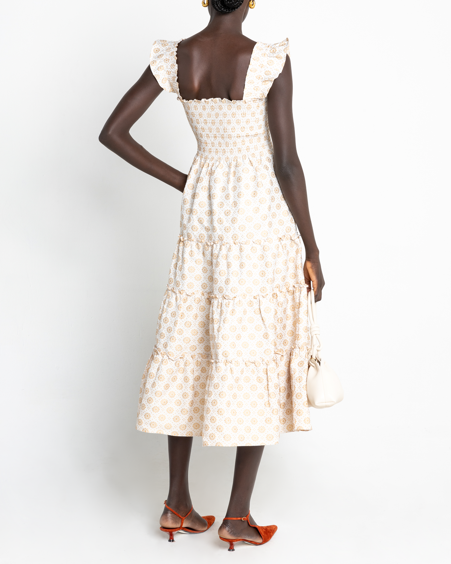 Second image of Calypso Maxi Dress, a white maxi dress, ruffle cap sleeves, smocked bodice, gold, floral