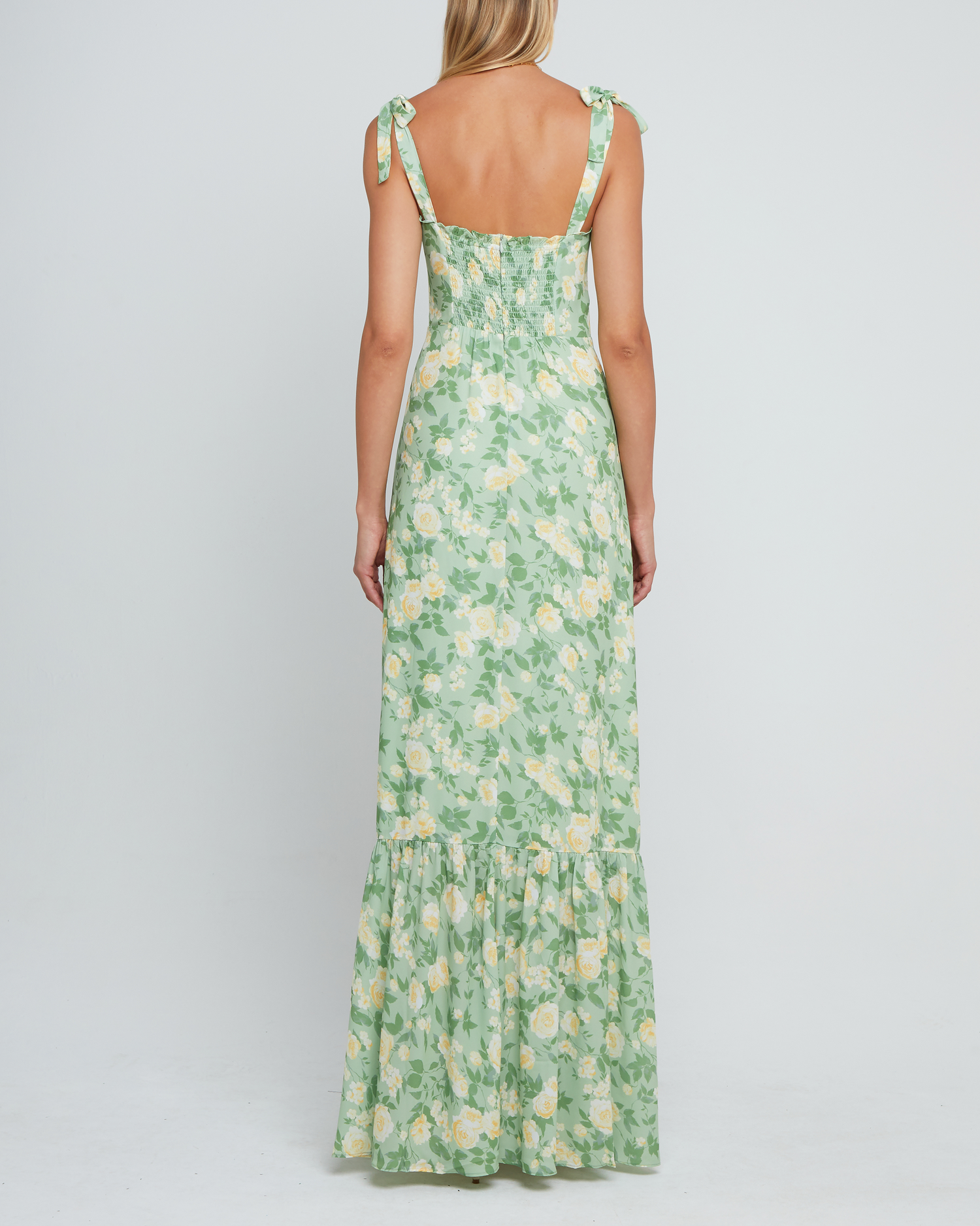 Fourth image of La Rue Dress, a sage floral floor-length bridesmaid dress with adjustable tie straps, cup detail, neckline ruffles, tiered skirt, lining, back smocking and back zipper