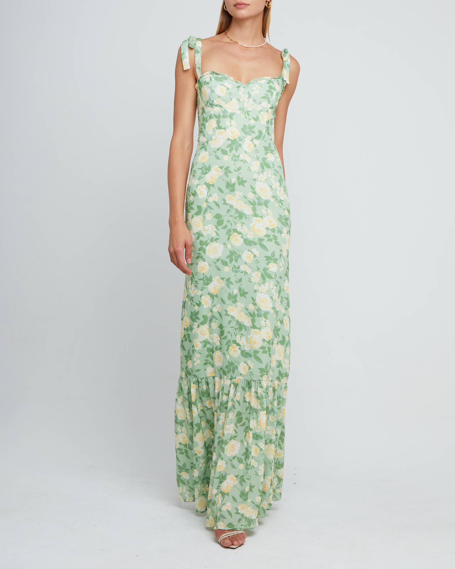 Sixth image of La Rue Dress, a sage floral floor-length bridesmaid dress with adjustable tie straps, cup detail, neckline ruffles, tiered skirt, lining, back smocking and back zipper
