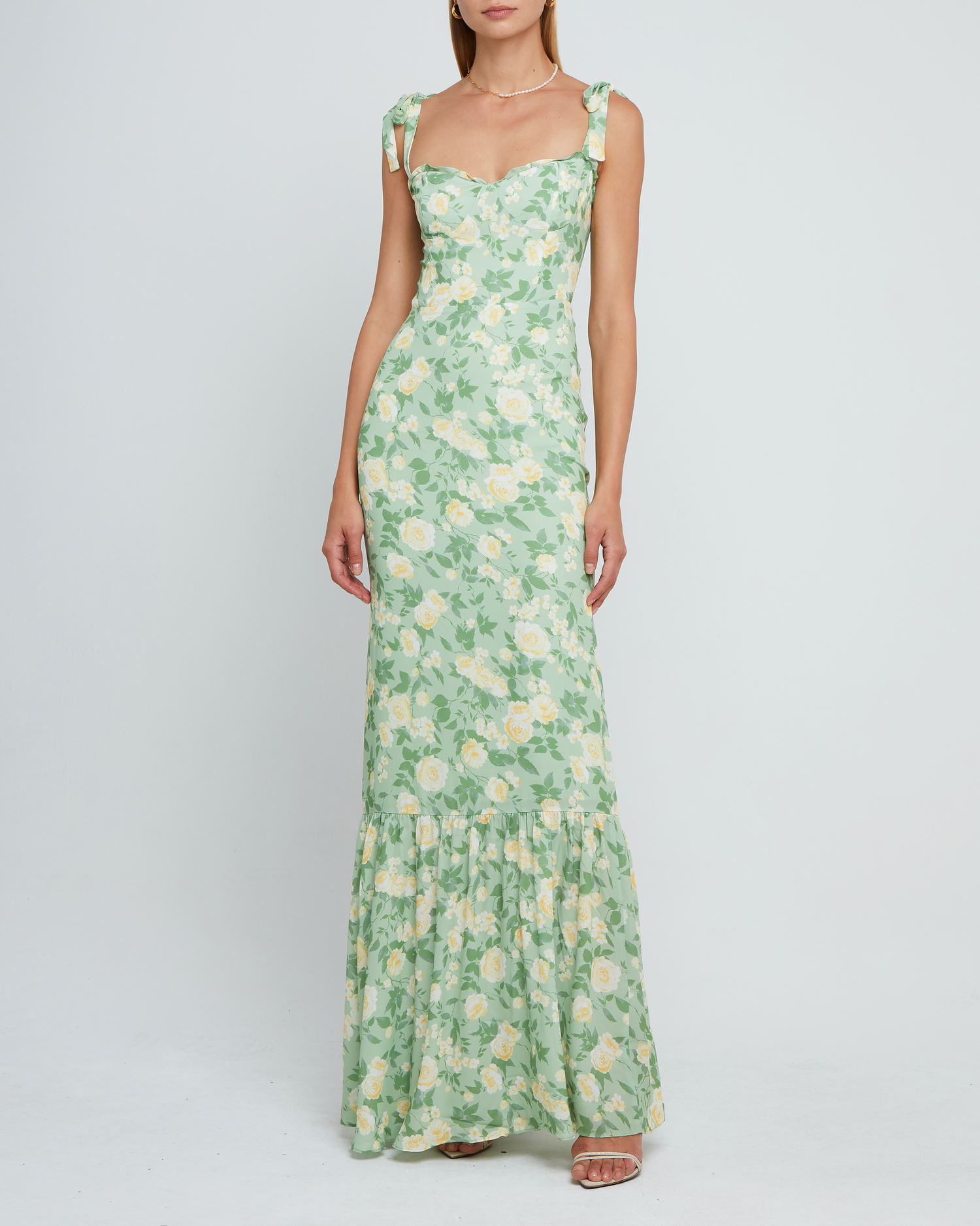 Third image of La Rue Dress, a sage floral floor-length bridesmaid dress with adjustable tie straps, cup detail, neckline ruffles, tiered skirt, lining, back smocking and back zipper