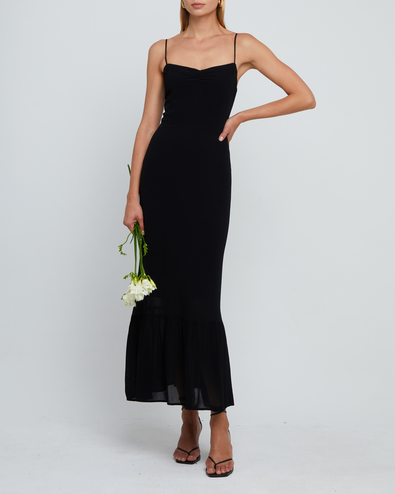 Sixth image of Evelyn Dress, a black bridesmaid maxi-length dress with ruched bust detail, sweetheart neckline, tiered skirt, back smocking, adjustable straps, back zipper, and lining