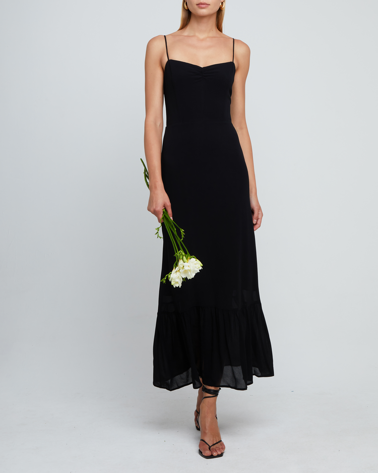 Third image of Evelyn Dress, a black bridesmaid maxi-length dress with ruched bust detail, sweetheart neckline, tiered skirt, back smocking, adjustable straps, back zipper, and lining